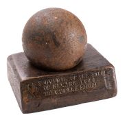 A 3.5 inch 5lb canon ball on wooden stand 'Souvenir of the Siege of Newark 1644.