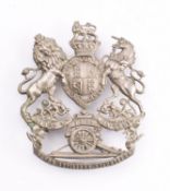 A 12th Devon Artillery Volunteers helmet plate pierced Queen's Crown Coat of Arms with legend over
