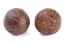 Two late 19th century gutta percha golf balls, Forgan style:, both unsigned, with line markings.