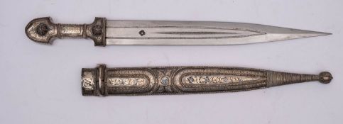 A white-metal mounted jambiya, the straight double edge blade with fuller,