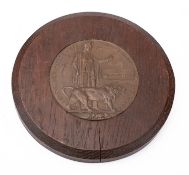 An oak mounted WWI Memorial Death Plaque for 'Guy Winterbottom', 22.5cm diameter.
