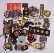 A quantity of various militaria comprising cloth badges etc (some reproduction)