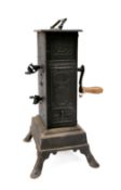 A 19th Century Continental clockwork spit engine in blackened tin and metal oblong casing,