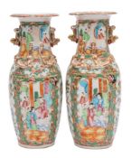 A pair of Canton baluster vases with applied gilt lion dog handles,