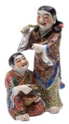 A Chinese famille rose group of the laughing Hehe Erxian twins wearing colourful robes,