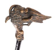 A patinated bronze group of a lion and a long-necked mythical bird mounted to a walking stick,