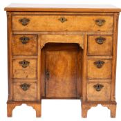 A walnut and crossbanded kneehole desk, in George II style,