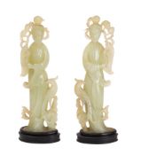 A pair of Chinese carved hardstone figures of female Immortals each holding a peach spray,
