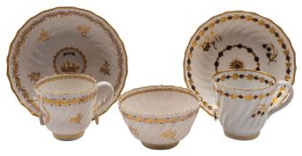 A Caughley 'L'Amitie' spiral-fluted trio and a similar blue and gilt cup and saucer the first