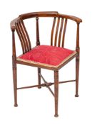 An Edwardian mahogany and sycamore strung corner elbow chair,