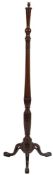 A mahogany standard lamp, early 20th century; the electrical fitment above a knopped,