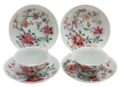 A pair of Chinese famille rose teabowls and saucers together with two matching saucers enamelled