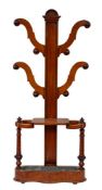 A Victorian mahogany hall stand, circa 1870; the straight shaft with semi-circular finial,