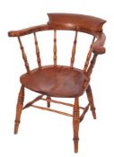 A Victorian oak 'smoker's bow' elbow chair, last quarter 19th century; of typical form,
