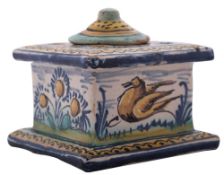 A Spanish Talavera inkwell and cover, of square form painted with a deer, a bird and flowers,