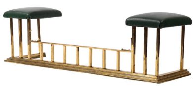 A brass and faux green leather upholstered club fender,
