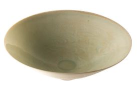 A Chinese celadon glazed bowl, probably Song and of thinly potted form on a shallow foot,