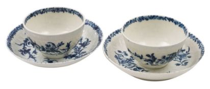 A pair of First Period Worcester blue and white tea bowls and saucers in the Feather Mould Floral
