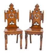 A pair of Victorian carved oak hall chairs in flamboyant Gothic style, third quarter 19th century,