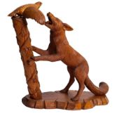 A carved and stained hardwood group of a fox and a partridge, by Les Jewell,