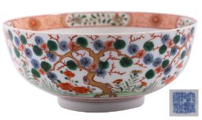 A Chinese porcelain bowl the exterior decorated with aged pine and peony,