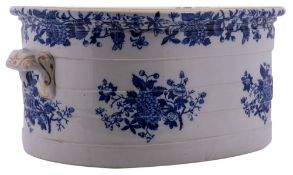 A pottery foot bath of banded oval form with scroll moulded handles,