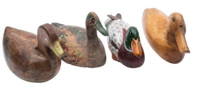 Four carved and painted wood decoy ducks, early 20th century and later, three with glass inset eyes,