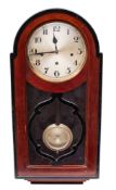 A German chiming wall clock having an eight-day duration spring-driven movement chiming the