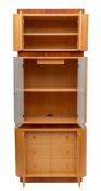 A pair of maple and cherrywood veneered and glazed armoires, modern,: each in three sections,