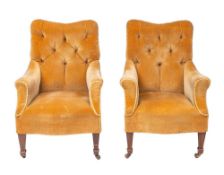 A pair of Victorian upholstered armchairs, late 19th century; each with buttoned back,