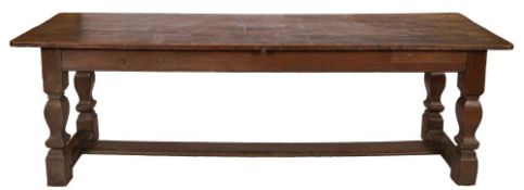 A German oak refectory table, circa 1700; the rectangular top above plain friezes,