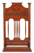 A Victorian oak and metal mounted billiard cue stand in Arts and Crafts style,