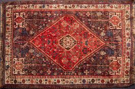 A Shiraz Rug the indigo field with a brick red hexagonal medallion,