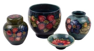Four pieces of Moorcroft pottery, tube lined in the Anemone pattern on a green ground,