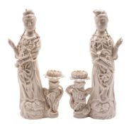 A pair of Chinese blanc de chine figures of Guanyin each wearing jewelled robes and holding a ruyi