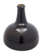 A transitional/mallet form wine bottle of green amber hue with raised neck,