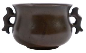 A small Chinese bronze censer of bombe form with flattened loop handles,