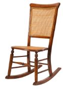 A Victorian beech and canework rocking chair,