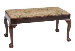 A carved walnut and tapestry upholstered long stool in George II taste, 46cm high,