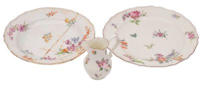 A Chelsea plate and a Derby cream jug: painted with scattered floral sprays, red anchor mark,