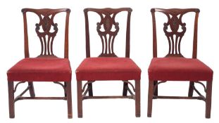 A set of three George III mahogany dining chairs,