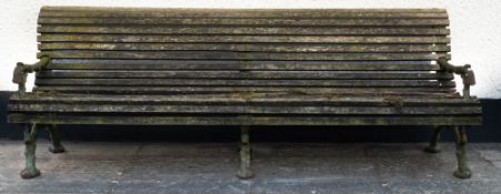 A late Victorian cast iron and slatted wood garden bench, in rustic style,