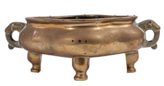 A Chinese bronze censer of quatrefoil form with stylised elephant head handles and embellished with