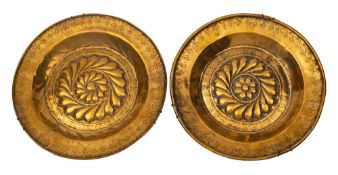 Two similar Nuremberg brass alms dishes,