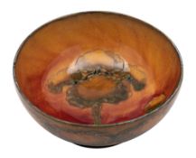 A William Moorcroft bowl the interior and exterior tube lined in warm tones in the Eventide pattern,