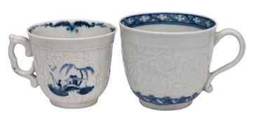 Two early Worcester blue and white cups one of strap fluted form with scroll handle and painted in