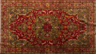 An Indo Persian Rug, the rose cartouche field with a central green pole medallion,