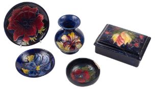 Five pieces of Moorcroft pottery, comprising a small vase in the Hibiscus pattern,