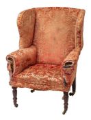 A late George III upholstered wing armchair,
