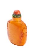 A Chinese amber snuff bottle of flattened ovoid form,